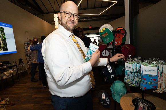 Commissioner O'Keefe checks out merchandise at the Visit Tallahassee Visitor Information Center.